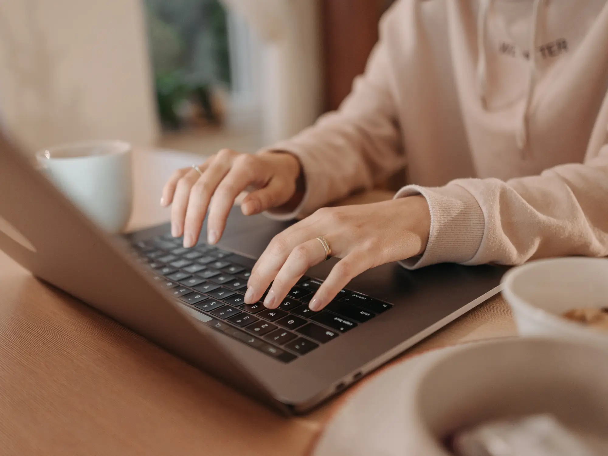 Woman typing on laptop.