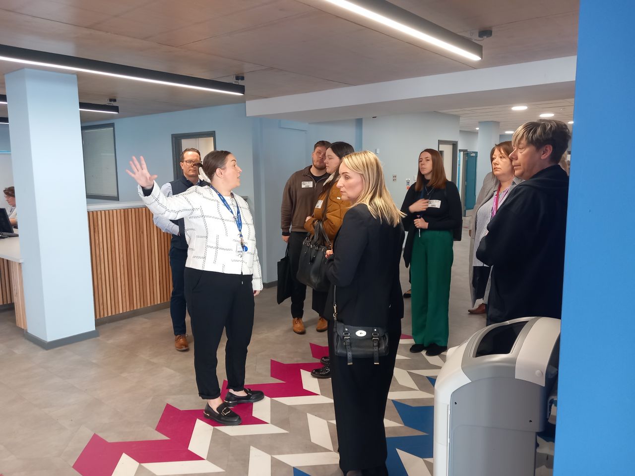 TEC Partnership staff and guests standing in the heart of the Grimsby Institute campus listening to a speech as part of the campus tour